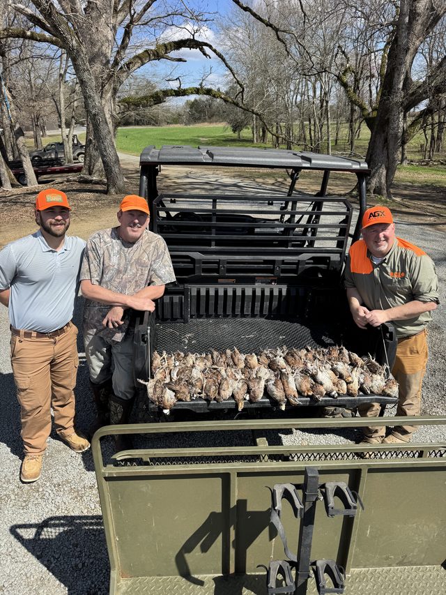 Three hunters behind a morning's bag at the buggy.